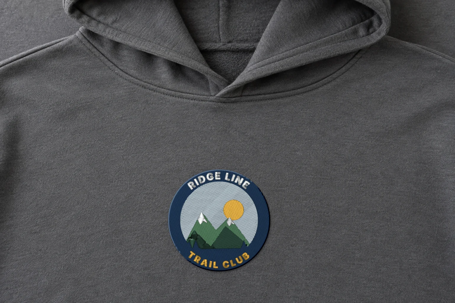 Mockup: the stitched round patch on the chest of a hoodie